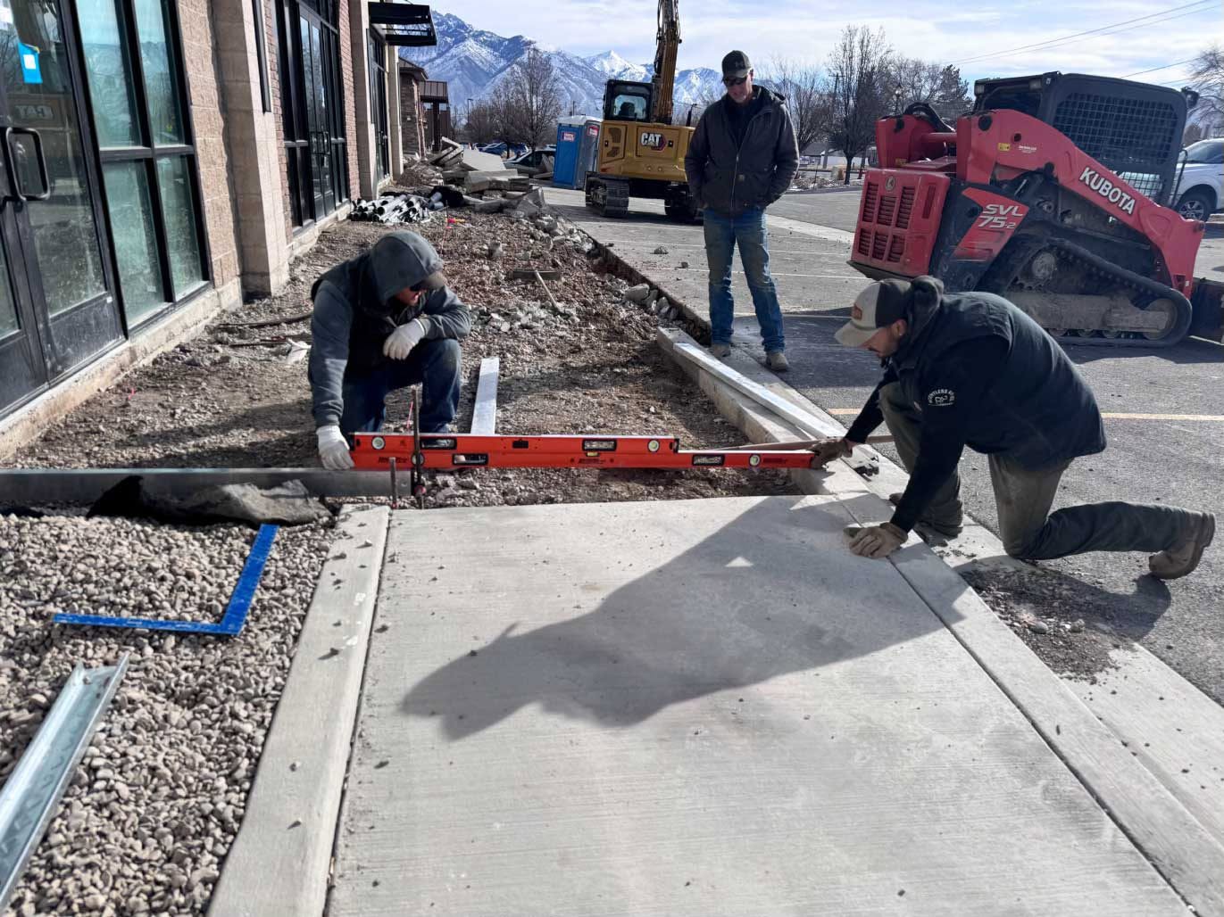 Crew placing and finishing concrete flatwork