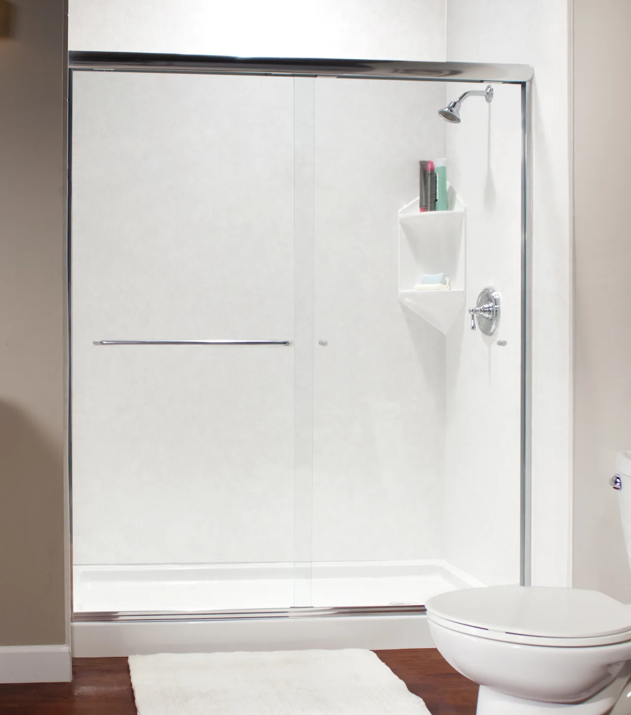 White shower base and walls with a chrome glass door
